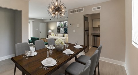a dining room and living room with a table and chairs